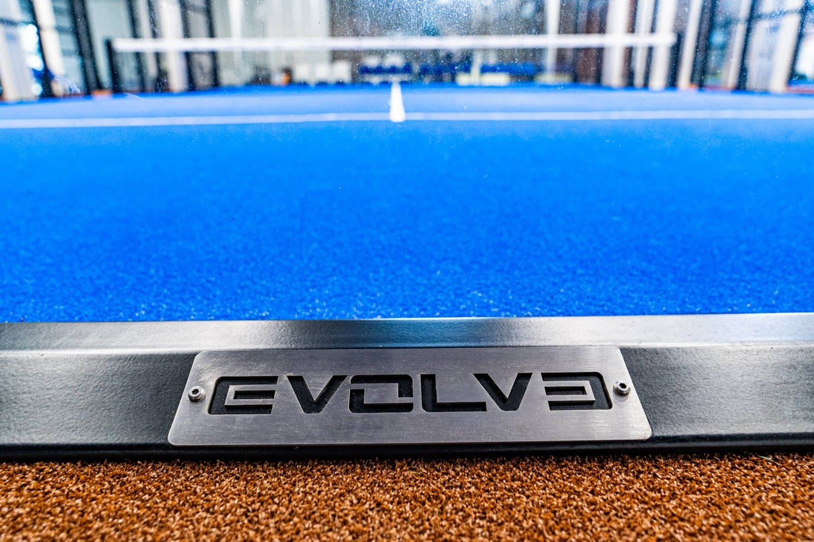 Stainless steel fixing detail on the base rail of an Evolve padel court